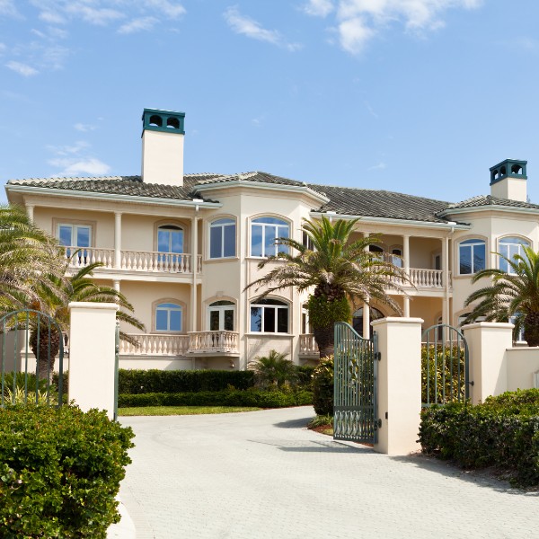 Well-maintained home entrance with palm trees and manicured shrubs — professional tree care estimates for Vero Beach homeowners